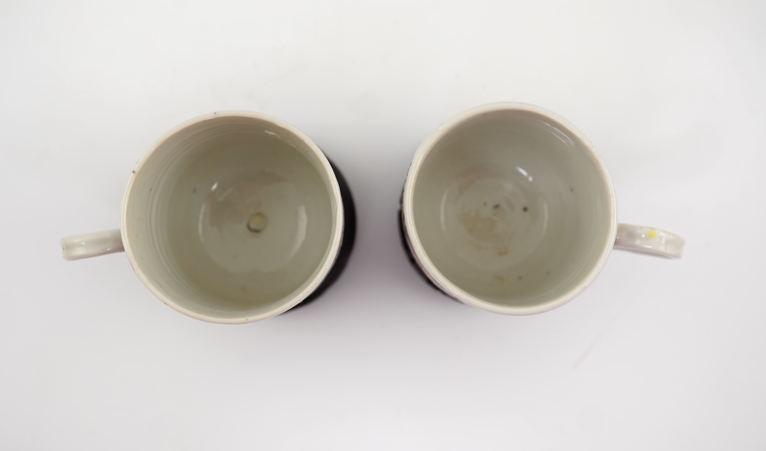 A near pair of Chinese famille rose ‘double pheasant’ coffee cups, early Qianlong period